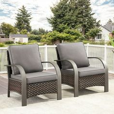 two chairs sitting on top of a patio next to each other