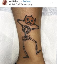 a skeleton with a jack - o'lantern tattoo on his foot is shown in this image