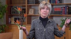 a woman standing in front of a book shelf