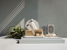 an assortment of items displayed on display in front of a gray wall with sunlight coming through the window