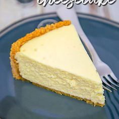 a slice of cheesecake on a blue plate with a silver fork and white napkin