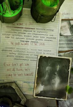 an old paper with writing on it sitting next to some green cups and other items