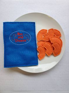 a white plate topped with orange slices next to a blue napkin