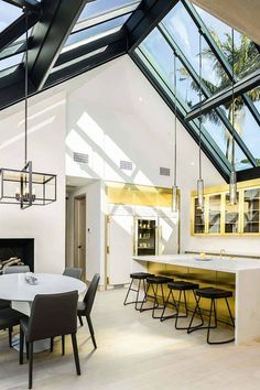 an open kitchen and dining room with skylights