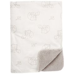 a white blanket with elephants on it and a light gray blanket underneath the blanket is folded in