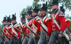 a group of men in uniform marching down the street