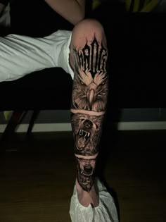 a man's leg with tattoos on it and an eagle in the middle of his leg