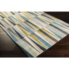 a rug that is on top of a wooden floor and has stripes in the middle