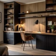 a home office with wooden paneling and black cabinets, including an l - shaped desk