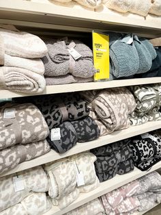 towels are stacked on shelves in a store