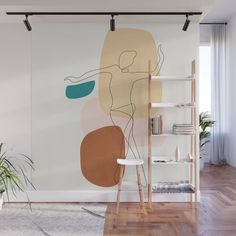 an abstract painting on the wall next to a chair and bookshelf in a living room