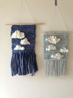 two handmade wall hangings with clouds on them