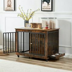 a dog crate sitting on top of a hard wood floor next to a white rug