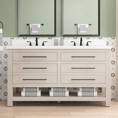 a bathroom vanity with two mirrors above it