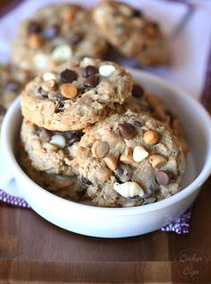 cookies and nuts in a white bowl on a wooden table