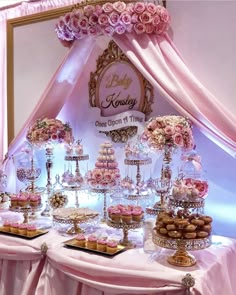 a table topped with lots of cakes and cupcakes