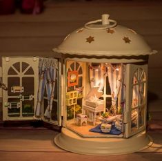 a doll house is shown with its lights on