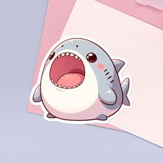 a sticker of a shark with its mouth open and it's tongue out