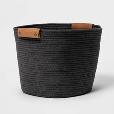 a large black basket with leather handles