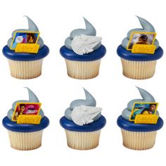 there are six cupcakes with pictures on them in the shape of shark tails