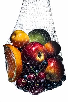 a mesh bag filled with assorted fruit