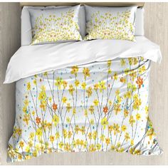 an image of a bed with yellow flowers on the comforter and pillowcases