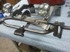 the front end of a motorcycle with two lights on it's handlebars