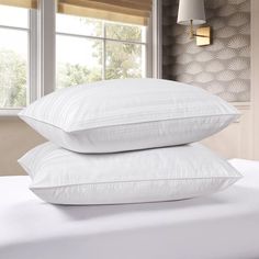 two white pillows stacked on top of each other