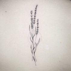 the back of a woman's neck with lavender flowers on her left side tattoo