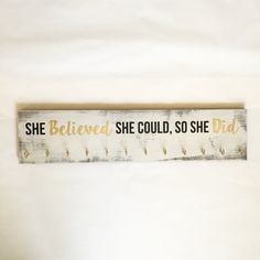 a wooden sign that says she belved she could, so she did on it