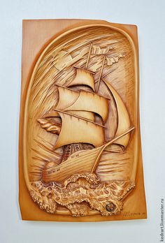 a carved wooden plaque depicting a sailing ship