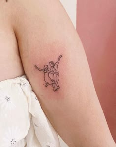 a woman's arm with a small tattoo of a man riding a skateboard