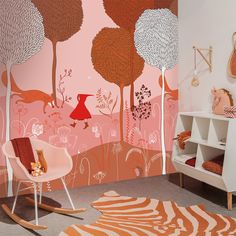 a child's room decorated in pink, orange and white with an animal theme