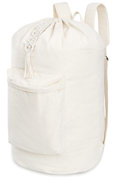 a large white bag with a tassel on the front and side pocket in the back