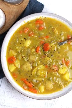 a bowl of soup with carrots and potatoes