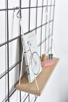 there is a book on the shelf with a bicycle attached to it and some other items