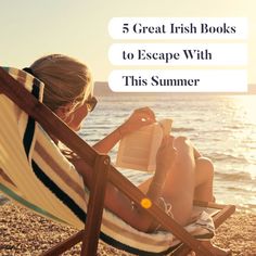 a woman reading a book while sitting in a chair on the beach