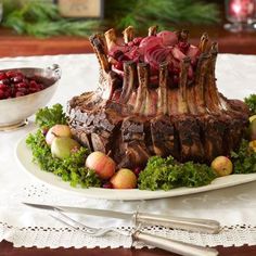 a large piece of meat sitting on top of a table next to fruit and vegetables