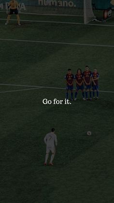 a group of people standing on top of a soccer field