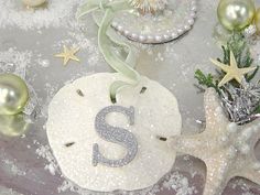 a table topped with snow covered dishes and ornaments