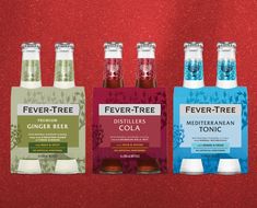 four bottles of fever tree cider and tonic on a red background with silver flakes