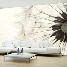 a living room with white furniture and a large dandelion wall mural