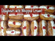 doughnuts with whipped cream and cherries are stacked on top of each other