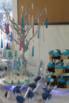 cupcakes and cakes are displayed on a table