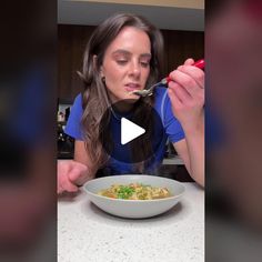 a woman eating food from a white bowl