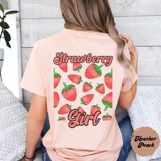 Welcome to the world of the cute and stylish "Strawberry Girl" shirt! With a cool design of juicy strawberries on the back and the trendy "Strawberry Girl" lettering, this shirt is an absolute must-have for all strawberry lovers out there. Show your love for this favorite fruity fruit and rock this summer with a touch of groove and freshness. Get your 'Strawberry Girl' shirt now and be ready to turn heads ♥ PRODUCTION TIME: 1-5 days (Usually 2-3 days)   ♥ SHIPPING TIME: 2-5 days (Usually 3 days) Sweet Short Sleeve Tops With Fruit Print, Cute Pink T-shirt With Strawberry Print, Cute Strawberry Print Shirt For Spring, Pink Strawberry Print Summer Shirt, Pink Strawberry Print Shirt For Summer, Pink Strawberry Print Shirt For Spring, Summer Pink Shirt With Strawberry Print, Sweet Summer Cotton Shirt, Sweet Cotton Summer Shirt