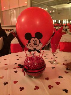 a mickey mouse balloon sitting on top of a table