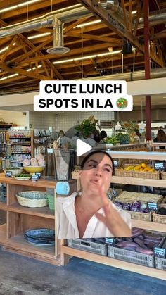 a woman sitting at a counter in a store talking on her cell phone with the caption cute lunch spots in la