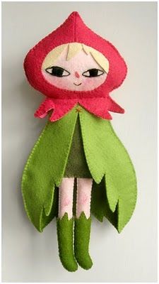 a red and green doll hanging on the wall