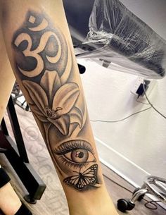 a person with a tattoo on their leg and an eye in the middle of it